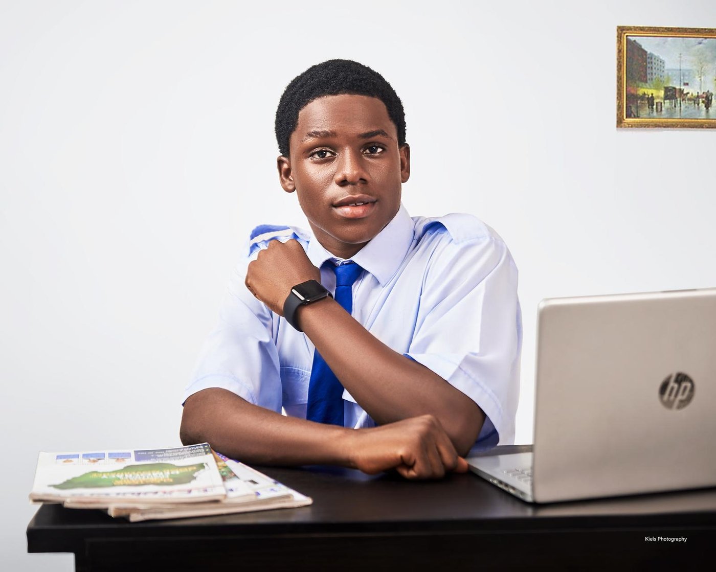 Victor Abuchi at his desk with a laptop